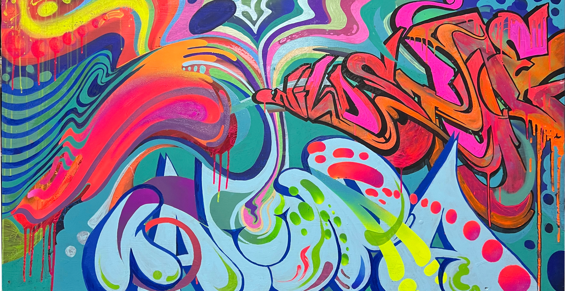 Large-scale graffiti mural with yellow accents on concrete wall